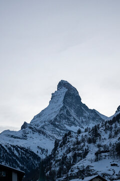 Matterhorn mountain peak rising above a snowy alpine landscape in winter, evoking skiing, mountaineering, adventure, and Swiss tourism.
