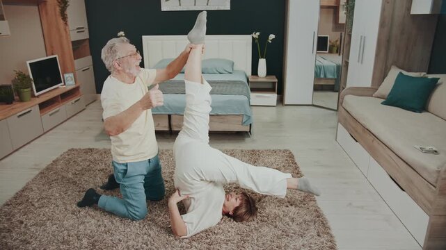 Partner-assisted supine leg raise, yoga-inspired floor exercise