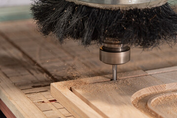A CNC router machine is precision-carving wood.