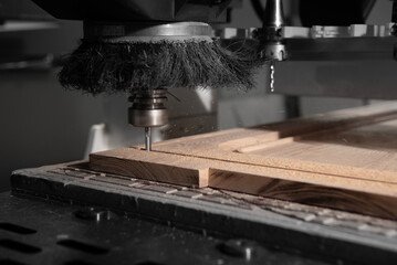 A CNC router machine is precision-carving wood.
