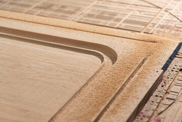 A CNC router machine is precision-carving wood.
