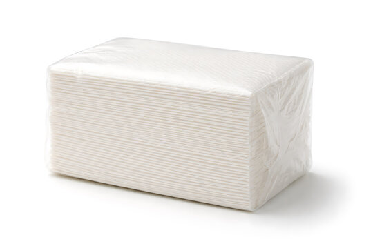 Stack of white paper napkins wrapped in plastic isolated on white background