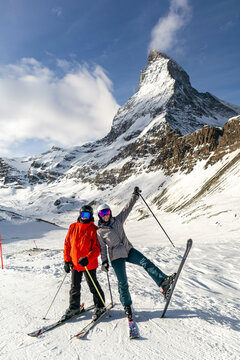 Skiers Posing Playfully on Zermatt Slopes with Matterhorn Mountain Backdrop