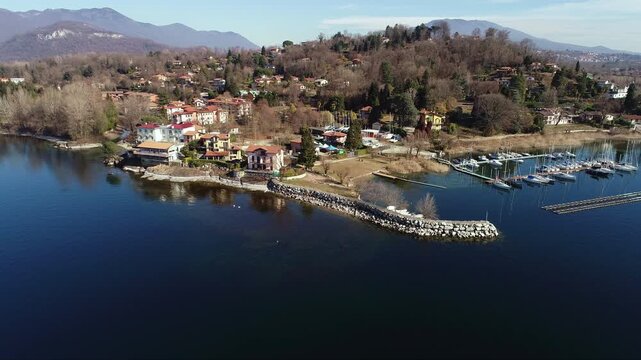 Aerial view of Sasso Moro harbor and Leggiuno lakeside village on Lake Maggiore, province of Varese, Lombardy, Italy