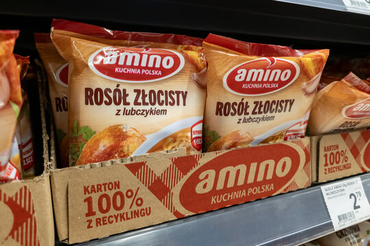 WARSAW, POLAND - JANUARY 21, 2026: Packets of Amino brand golden chicken soup instant noodles displayed on a supermarket shelf in a recycled cardboard box