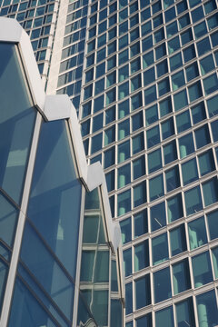 WARSAW, POLAND - JANUARY 22, 2026: architectural view showing the geometric glass facade of the Widok Towers, zigzag roofline of the PKO Rotunda building 