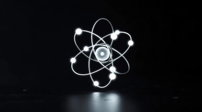Atom structure with glowing electrons on black background  