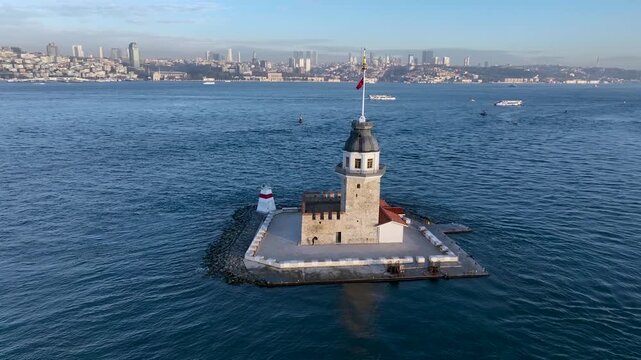Maiden's Tower. 4k aerial orbit drone view at sunrise in Bosphorus Strait. Shot of the Kiz Kulesi in istanbul, Turkey, situated in the sea at sunset popular tourist destination in the world.