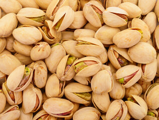 Roasted salted pistachio nuts in shell background texture