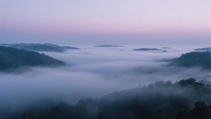 Fototapeta premium Misty Mountains at Dawn - A Serene Landscape of Fog and Hills.