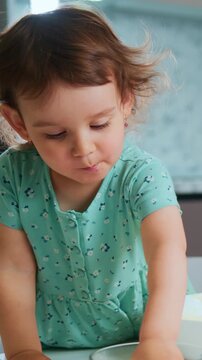 precocious toddler engaging in kitchen activity, inquisitive preschooler experimenting with batter and motion