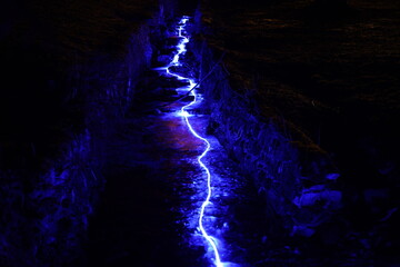 Illuminated mountain stream in winter, Korytnica, Slovakia.
