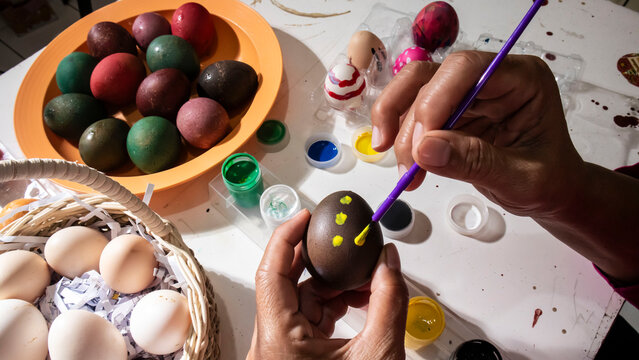 woman painting easter eggs