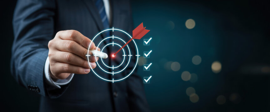 Business goal setting concept with businessman using digital stylus to target center of dartboard, symbolizing strategic planning, objective alignment, achievement checklist for organizational success