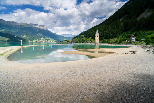 Submerged church tower of Alt Graun in Lake Reschen in South Tyrol, Italy