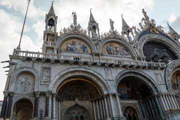 Fototapeta premium It is cathedral church of Roman Catholic Archdiocese of Venice. It lies at Piazza San Marco. Tourists walking in front of it. Venice, Italy