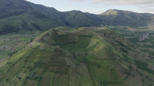 Aerial view of Chu Dang Ya extinct volcano with lush green hills and farmland, showcasing volcanic landscape, rural life, and Central Highlands of Vietnam.