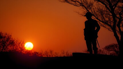 Fototapeta premium Soldier memorial silhouette at sunrise peaceful reflective mood