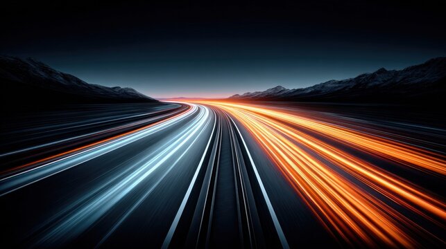 Long exposure highway light trails at dusk with mountains in the background