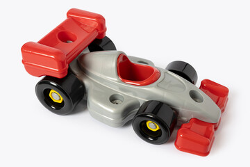 Obraz premium Plastic toy racing car with red and silver colors isolated on white background