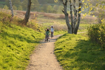 Obraz premium 2 Children in bikes on a path in nature in Denmark