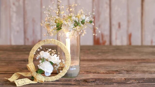 Florist at work: woman shows how to make small wreath with carnation flowers and gypsophila paniculata twigs. Step by step, tutorial. Images available.