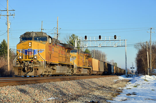 A pair of Union Pacific Railroad locomotives lead an empty coal train westbound through a western Chicago suburb while destined for the Wyoming coal mines to secure a new unit train load..