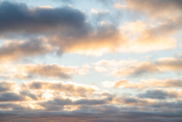 Fototapeta premium Beautiful clouds in the sky in pink and yellow shades at sunset or sunrise