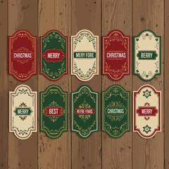 Naklejka premium a set of 10 vintage-style, decorative, holiday, Christmas, merry, best, and happy new year labels on wooden background