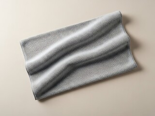 Textured gray cloth draped artfully against a neutral colored surface