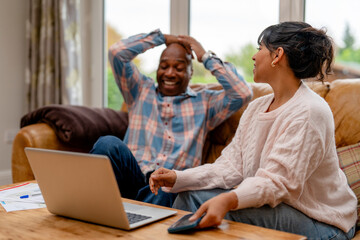 Couple sharing a moment of joy during a casual conversation at home in the afternoon