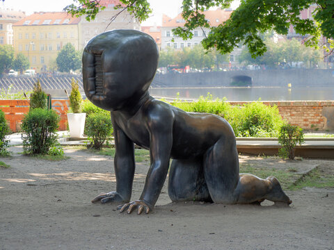 PRAGUE,  CZECH REPUBLIC - JULY 18, 2019:  Giant Baby statue (by David Cerny's) in Kampa Park beside Kampa Museum