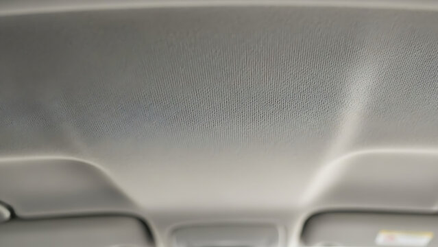 Dirty car headliner with stains and grime buildup inside vehicle