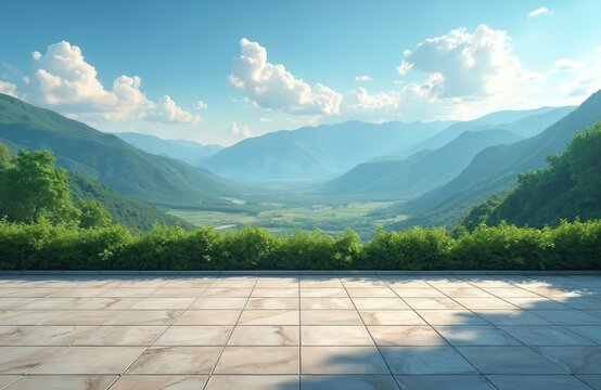 Scenic valley landscape with verdant rolling hills under a bright blue sky with fluffy white clouds. A paved terrace in foreground overlooks lush green nature. Perfect outdoor setting.