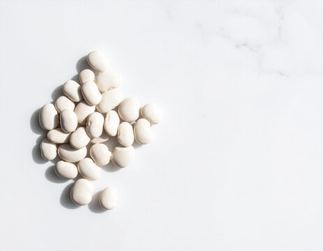Navy beans on white marble background with copy space