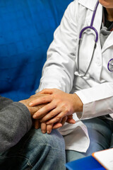 Doctor providing emotional support to patient, holding hand during consultation for comfort and empathy in healthcare setting