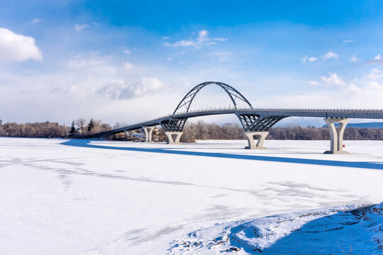 Crown Point Bridge in winter with frozen Lake Champlain and early morning sun. From NYS looking into Vermont.