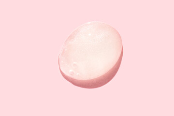 Pink gel bubble on soft pink background with highlights and shadows reflecting light.