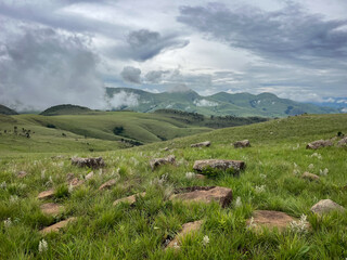 Malolotja National Park Eswatini, summer mountain landscape with clouds and rocks in the foreground