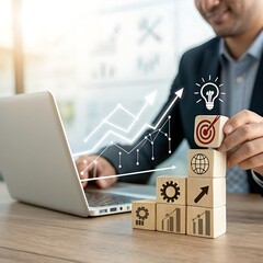 Businessman stacking wooden blocks with business icons and graph