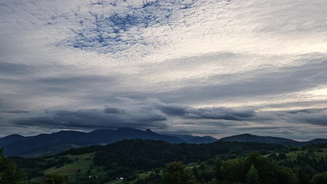 timelapse of Altocumulus stratiformis clouds moving fast at evening.
