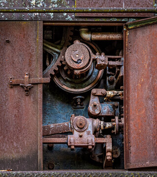 Rusted mechanics within a vintage railroad car in Cass, West Virginia
