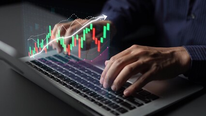 A close-up shot of hands typing on a laptop, with a dynamic stock market graph overlay, illustrating financial growth trends and investment analysis in a modern business environment. Copula