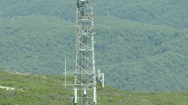Drone vertical rise aerial footage of a large telecommunication tower on the ridgeline of the Jamison Valley in the Blue Mountains in New South Wales, Australia.