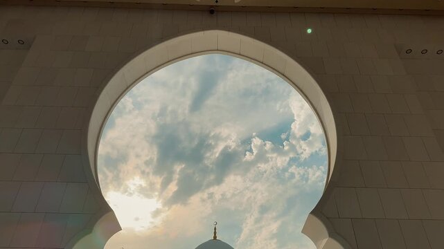 A majestic view of the Sheikh Zayed Grand Mosque in Abu Dhabi. This clip showcases the stunning Islamic architecture, white marble domes, and floral courtyard at sunset.

