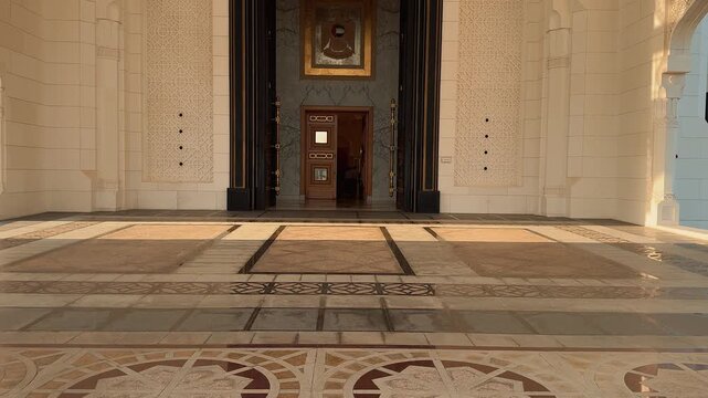Breathtaking footage of the Qasr Al Watan Presidential Palace in Abu Dhabi, showcasing the grand white exterior at sunset and the intricate Islamic architecture of the entrance hall.

