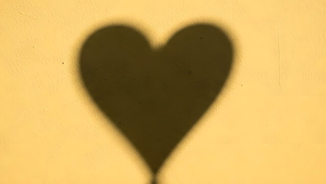 Heart Shadow on Yellow Wall (781) stock
