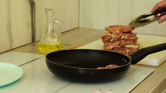 The process of cooking meat in a pan
