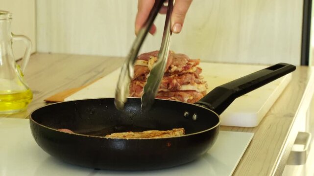 The process of cooking meat in a pan