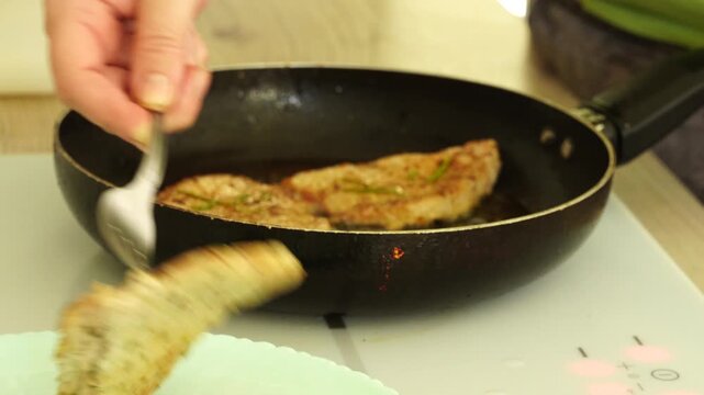 The process of cooking meat in a pan